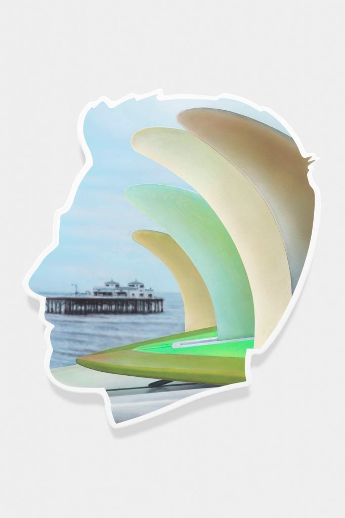 A painting in the shape of a man's profile with inside a picture of a large-scale shipping boat and brushstrokes of greens and beiges.
