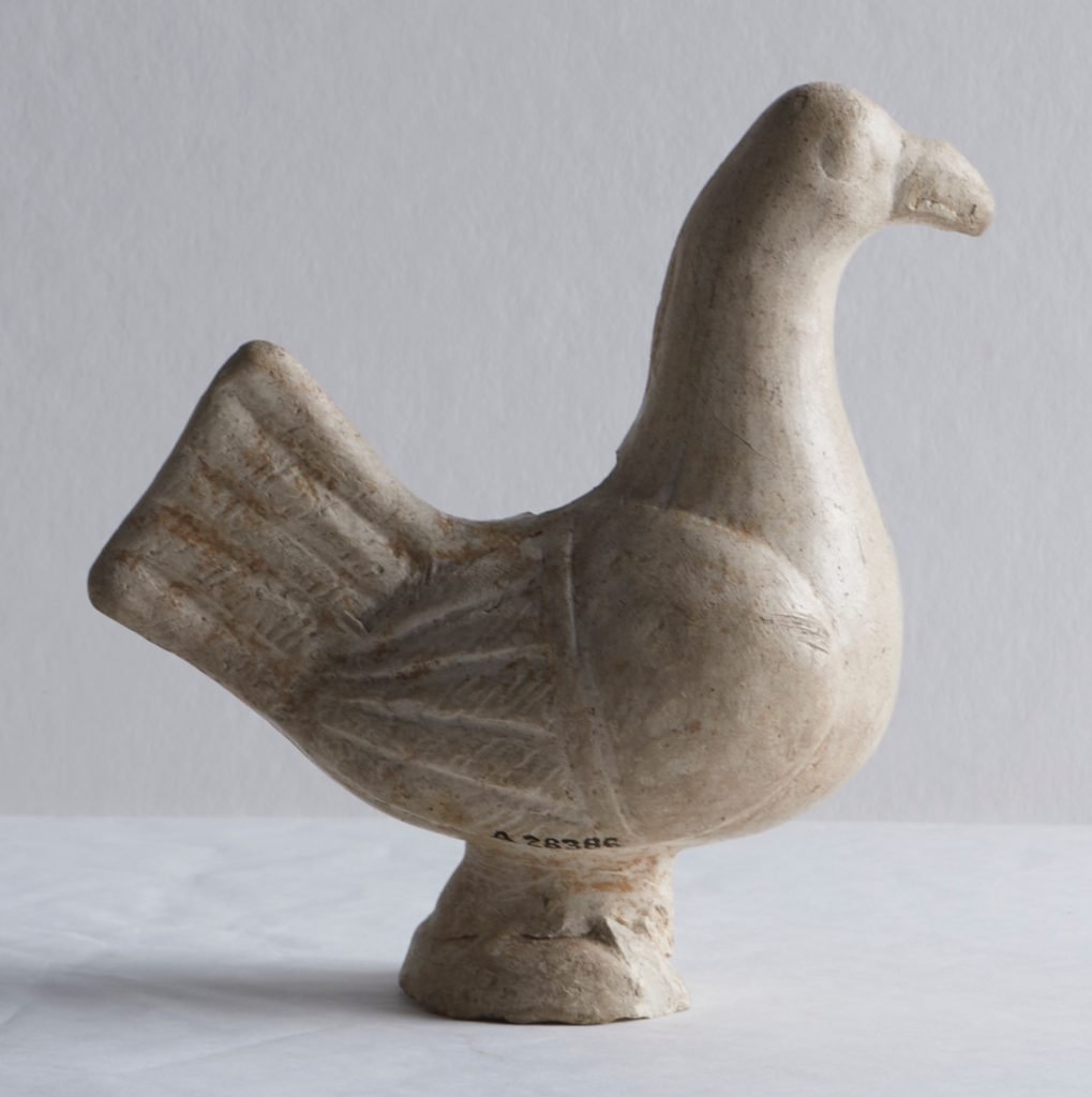 a small old figurine of a bird