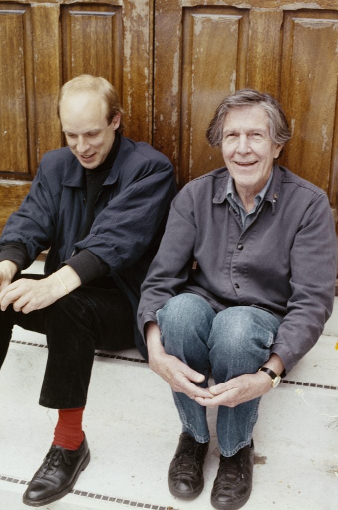 Two men sitting on the stoop of a building