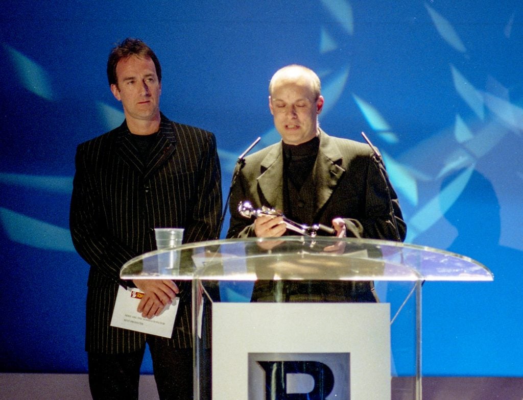 A man accepts an award onstage