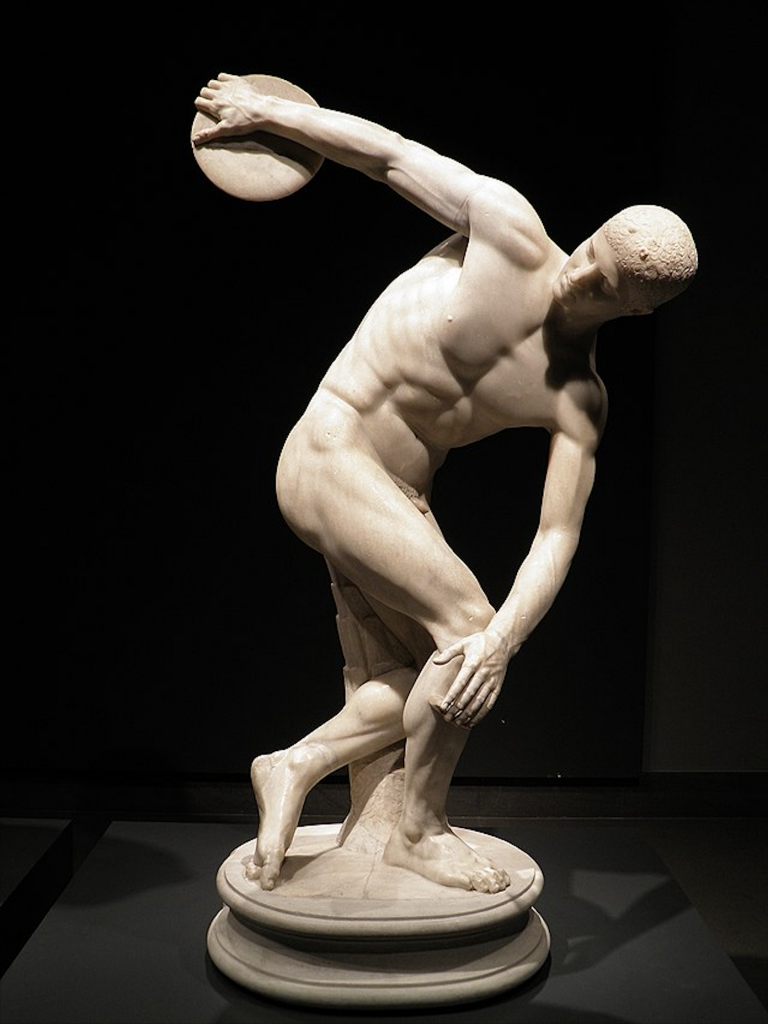A marble Discobolus sculpture of a nude man in the midst of throwing a discus, looking back at the disc before throwing.