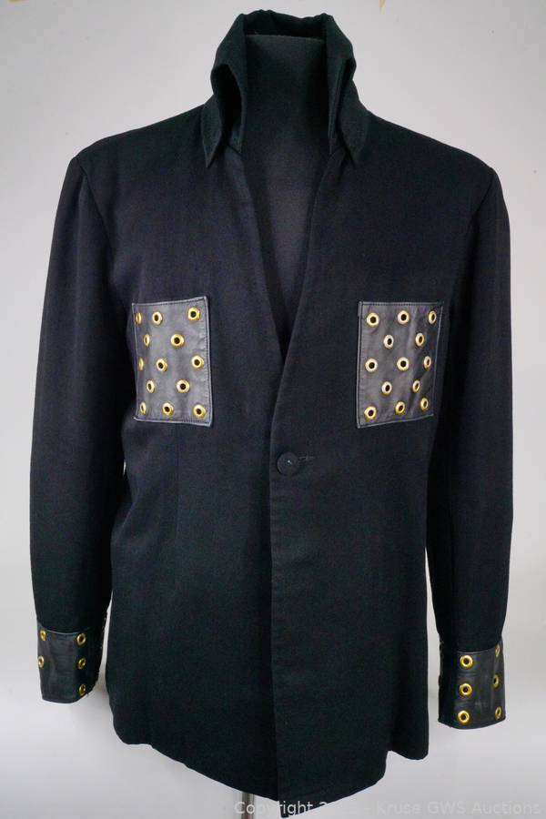 A black long-sleeved jacket with leather cuffs and breast pockets decorated with brass grommets said to have been owned by Elvis Presley.