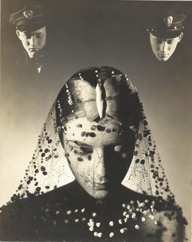 A black and white portrait of a woman looking down wearing a bejeweled veil with ghostly portraits of a police officer in the top right and left of the image. presented by Mitchell algus gallery at independent 20th century.