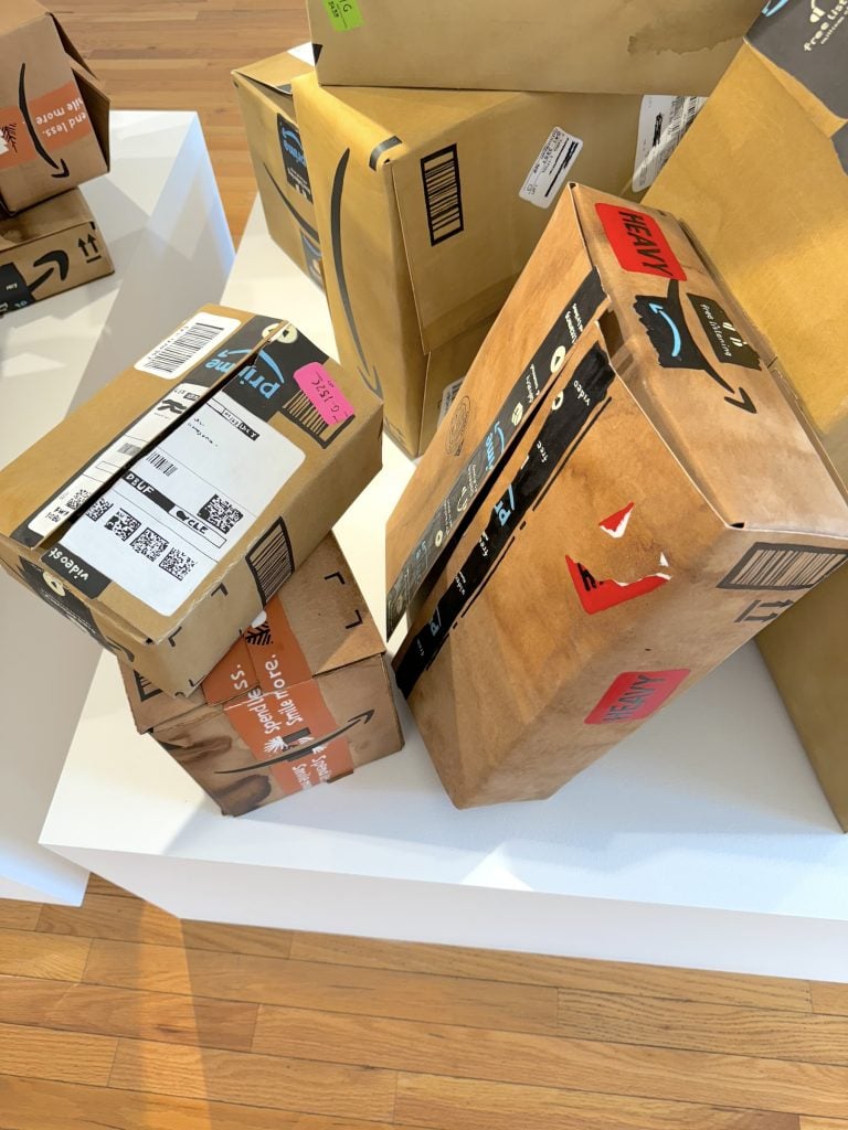Sculptures that look like cardboard Amazon boxes