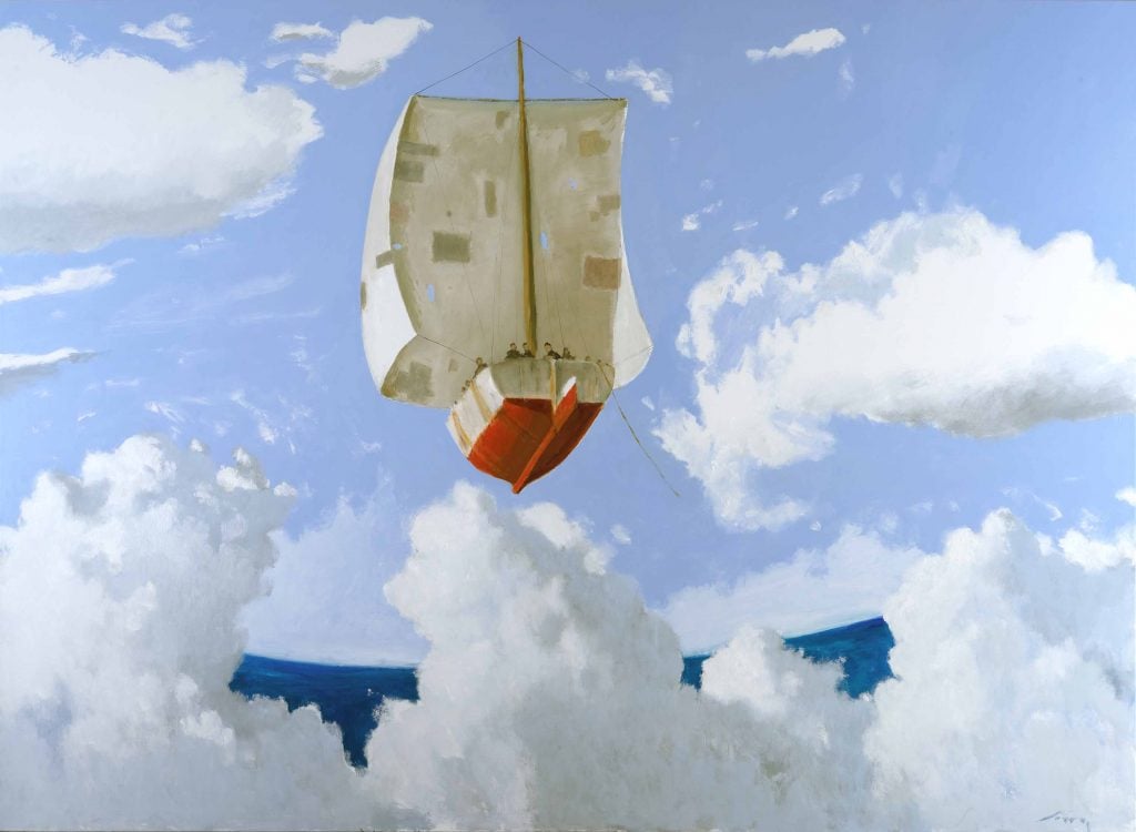 A massive sail boat with patched sail and red hull drifting across a blue sky with white clouds high above a dark blue ocean.