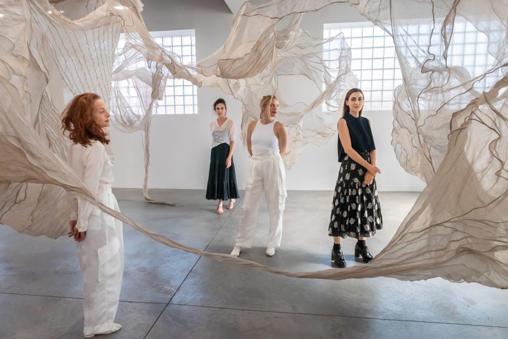 Four person portrait inside textile installation work at Carvalho Park gallery, Left to right: Jodi Melnick, Diana Orving, Sara Mearns, and Jennifer Carvalho.