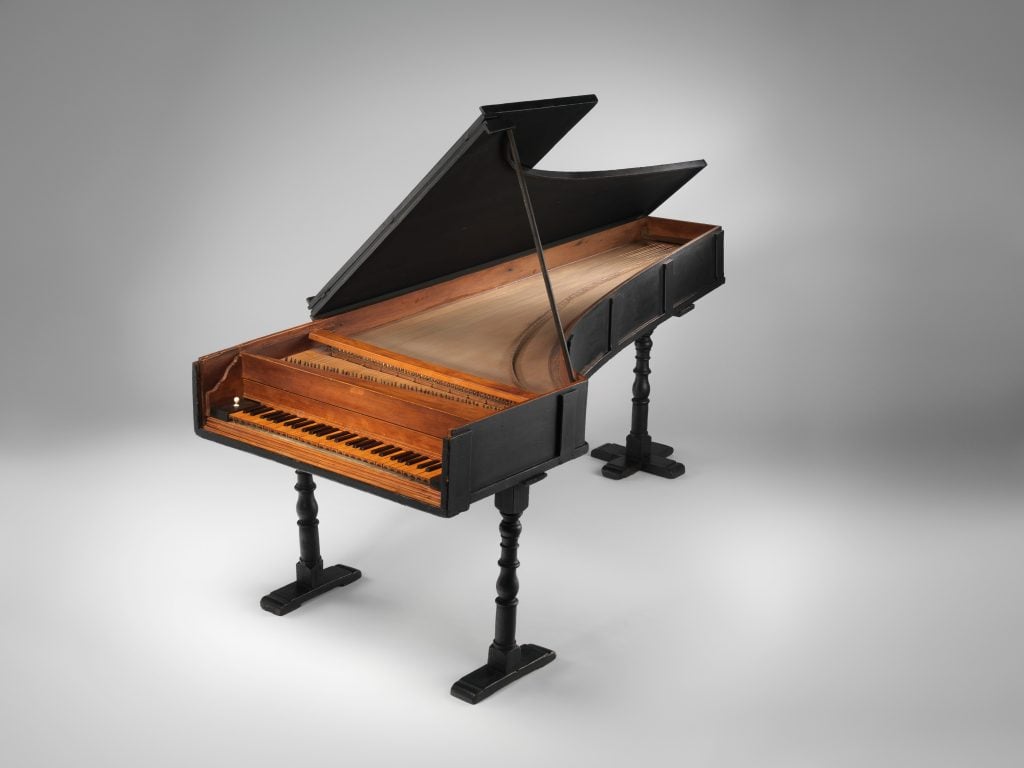 A 1700 grand piano by Bartolomeo Cristofori, its outer body in black wood and the inner in brown