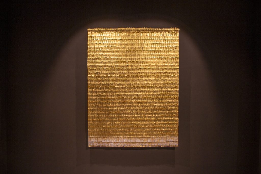 A tapestry made of woven strips of gold by Olga de Amaral.