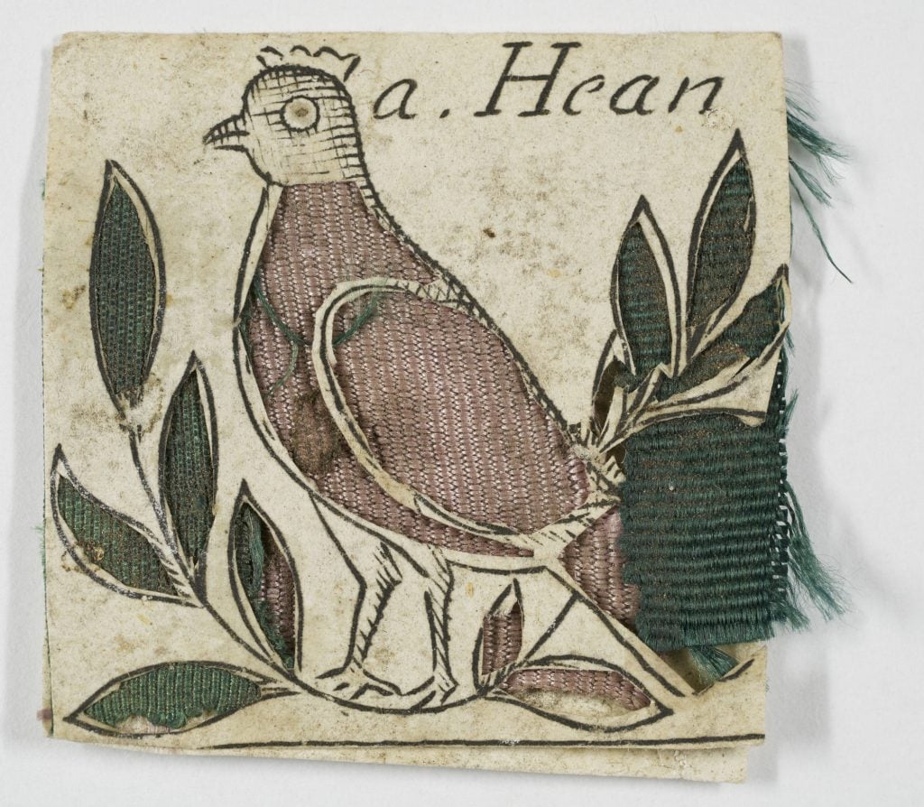17th-century paper cutout depicting a hen standing amid a leaf branch