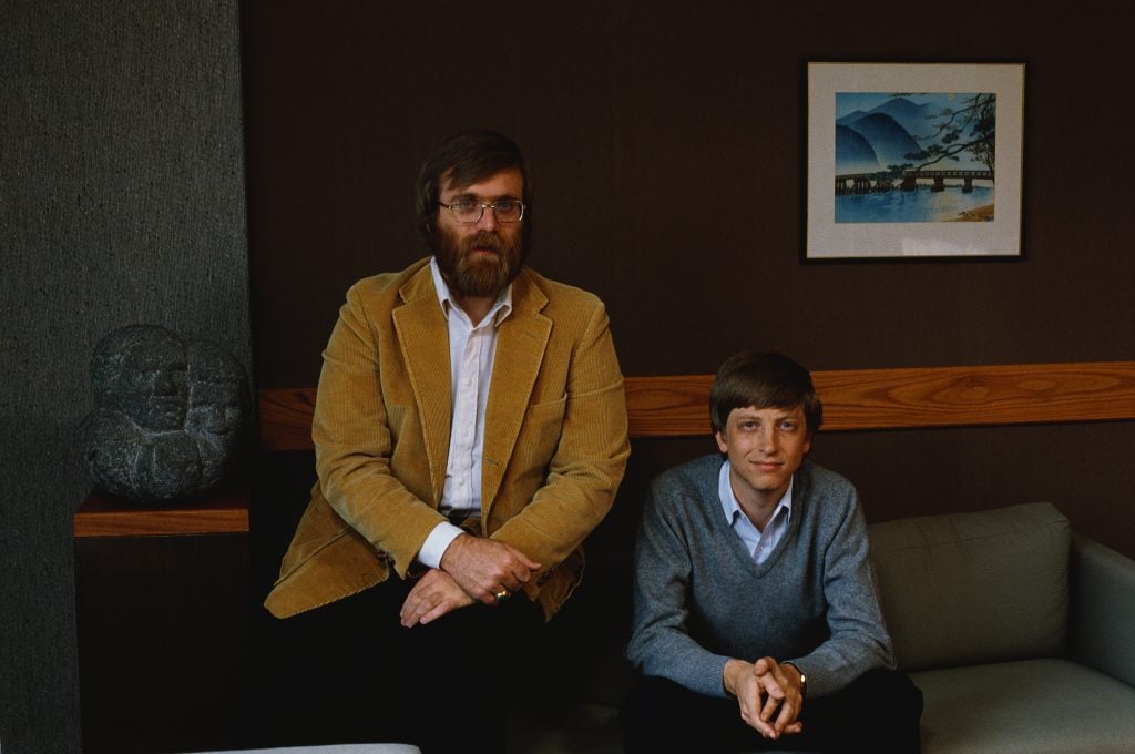 Paul Allen and Bill Gates sitting in a wood-paneled office