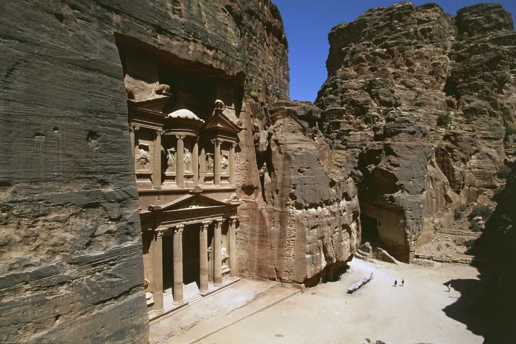 An elaborate facade carved out of the side of a mountain.