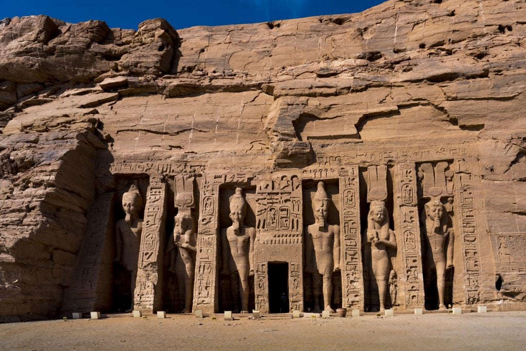 The entrance to an ancient Egyptian temple, with five standing statues