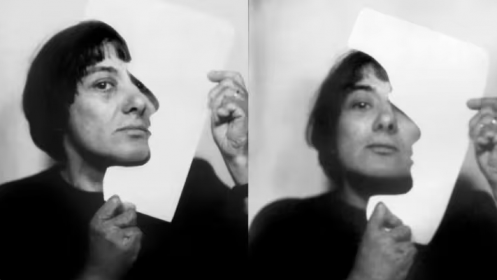 two black-and-white photograph of a woman with black hair holds up with a white paper cutout which she holds up to his face