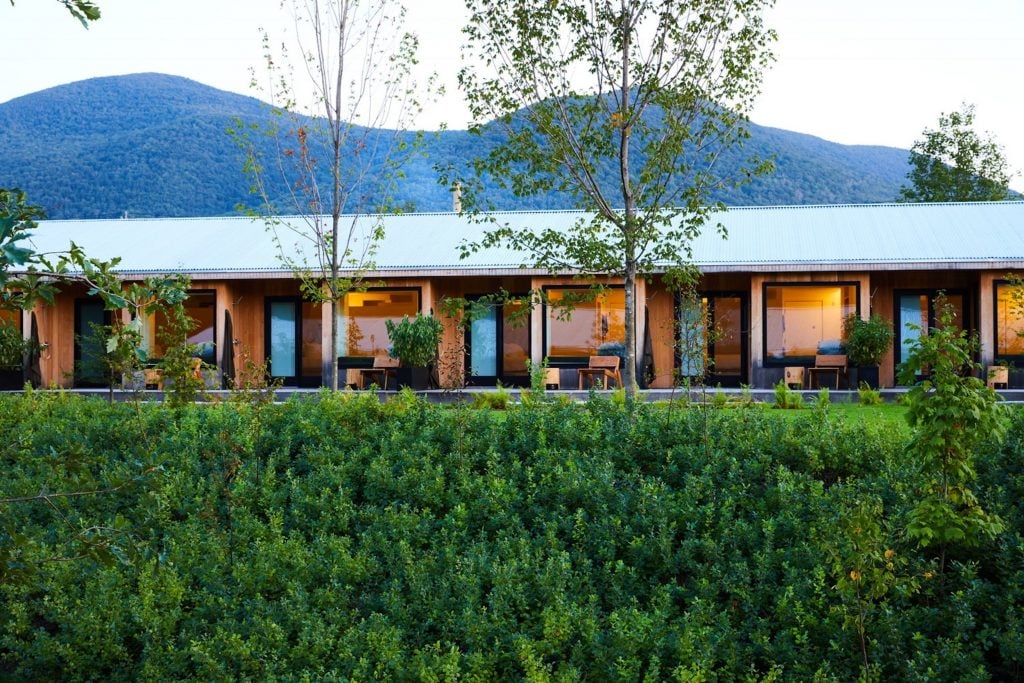 A fashionable hotel exterior in a lush bucolic setting