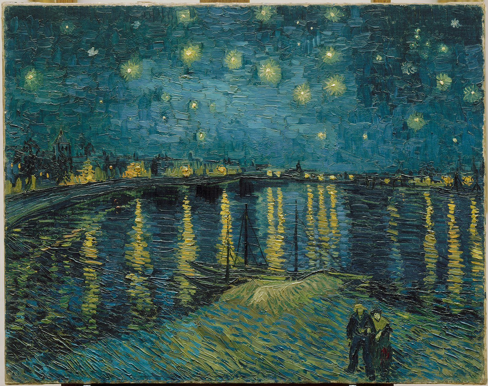 Vincent Van Gogh's painting of a night sky, reflected in the River Rhone, with two people in the foreground