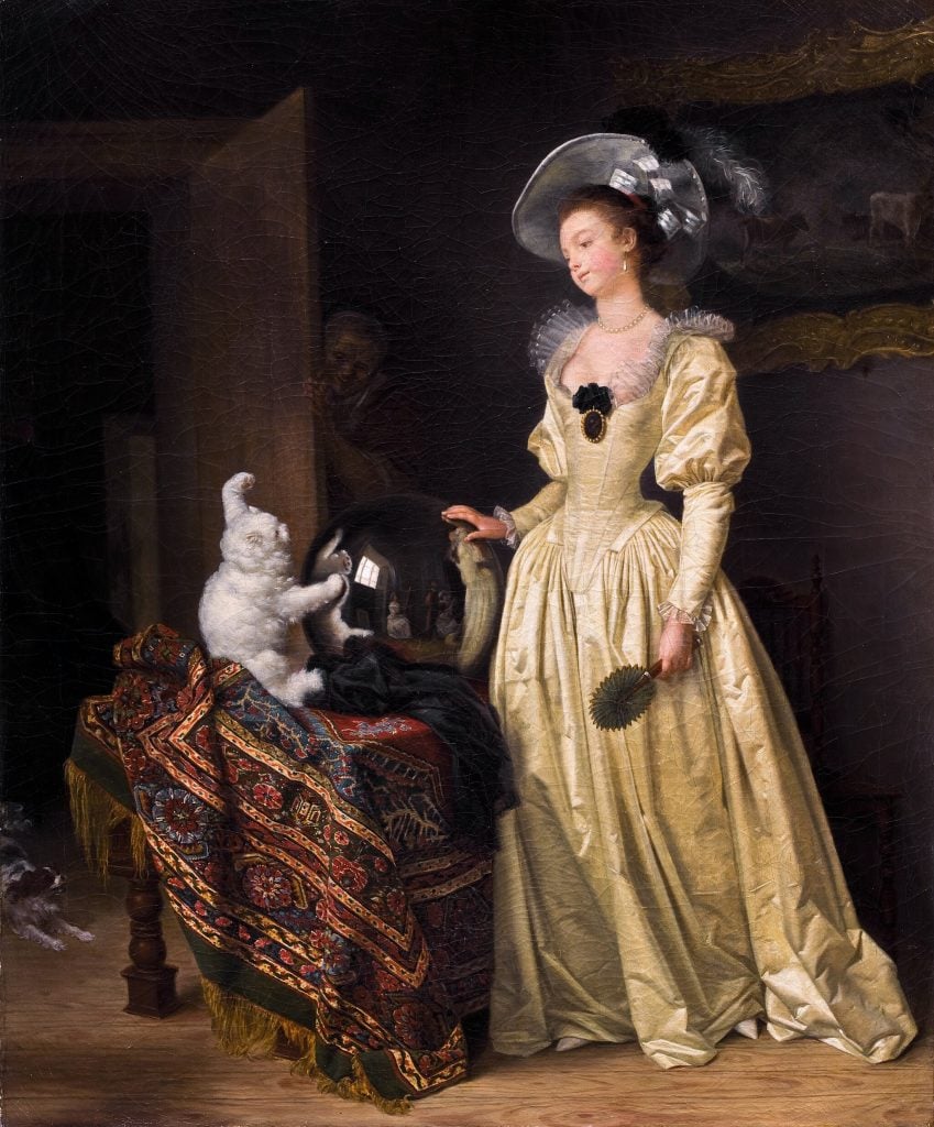 a fancy 18th century woman standing next to a cat