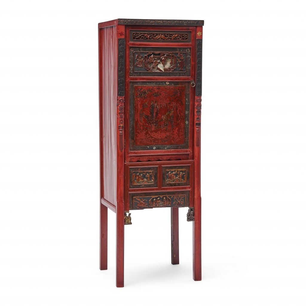 a small wooden cabinet decorated with red lacquer