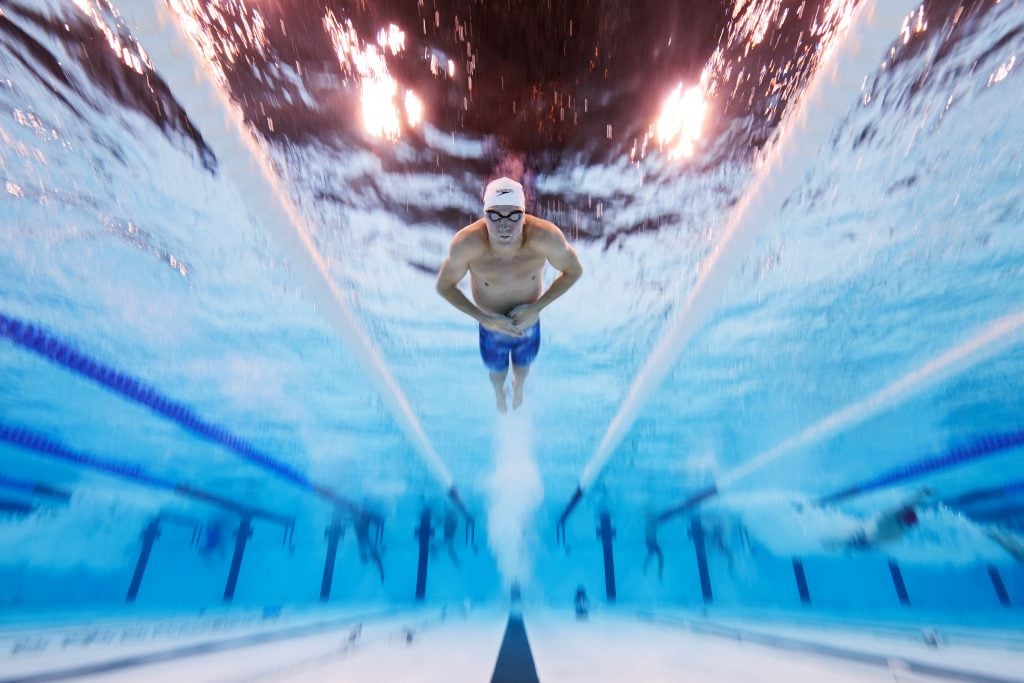 Adam Pretty used an underwater robotic camera to take this photo of U.S. swimmer Charlie Swanson competing in the Mixed 4x100m Medley Relay Heats at the 2024 Paris Olympic Games. The swimmer is dead center in the pool, and the water is flowing around him due to the slow shutter speed used to take the photo.