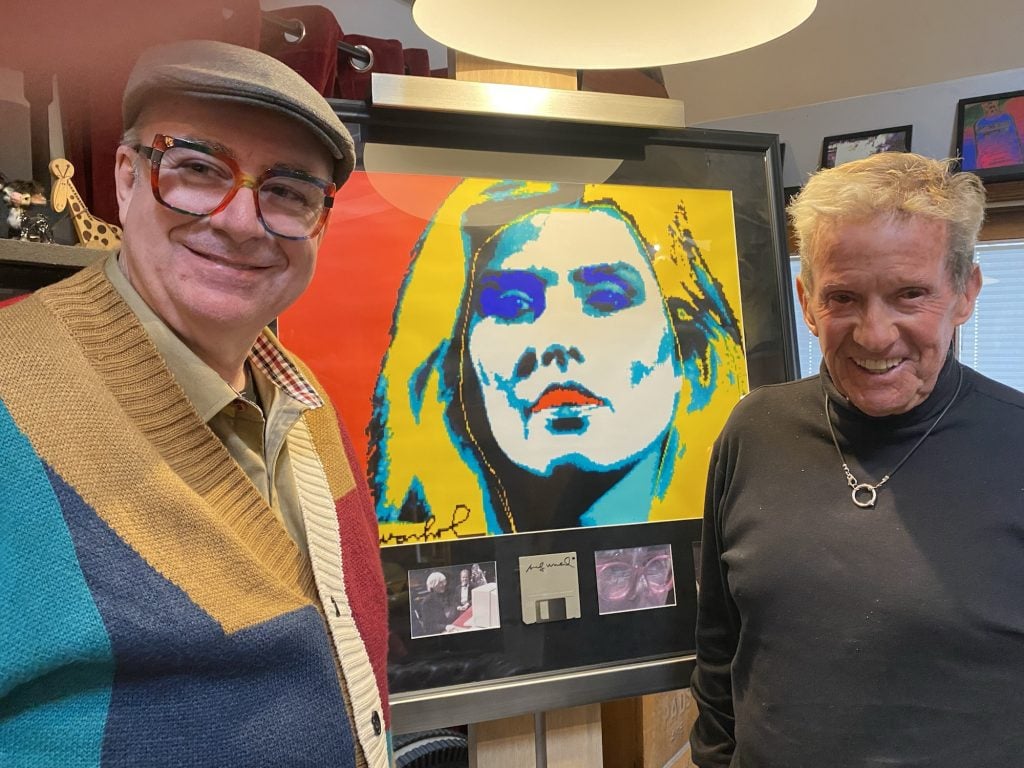 a portrait of Blondie lead singer Debbie Harry created by Warhol using an Amiga computer with owner and art dealer standing on either side