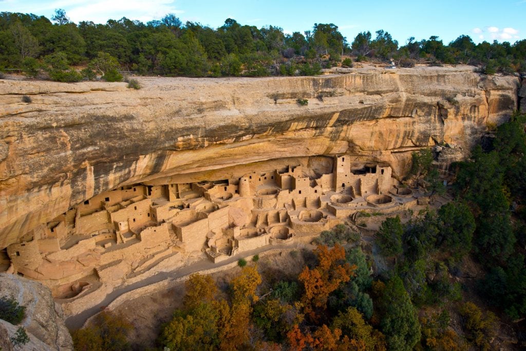 an aerial photograph of Cliff Palace built out of the rocks with blue sky above