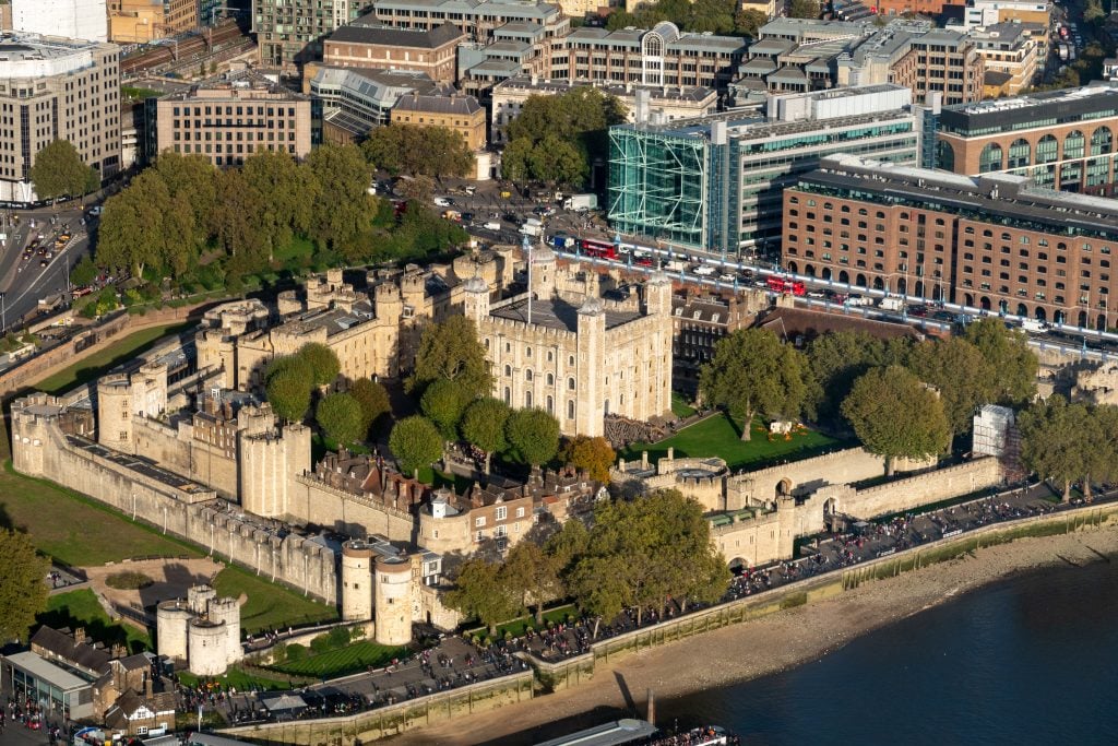 an aerial photo of the Tower of London surrounded by development.