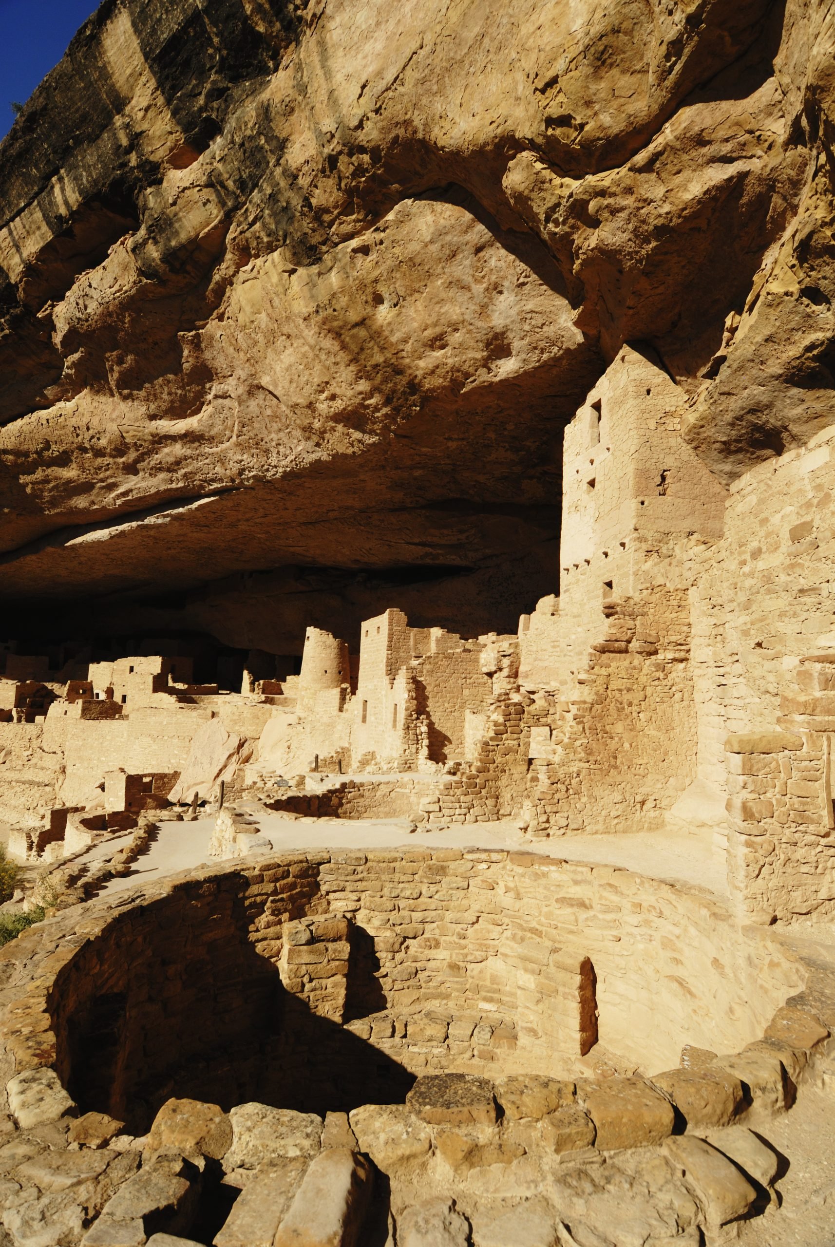 round hole, known as a kiva, surrounded by the cliff dwelling settlement in Cliff Palace