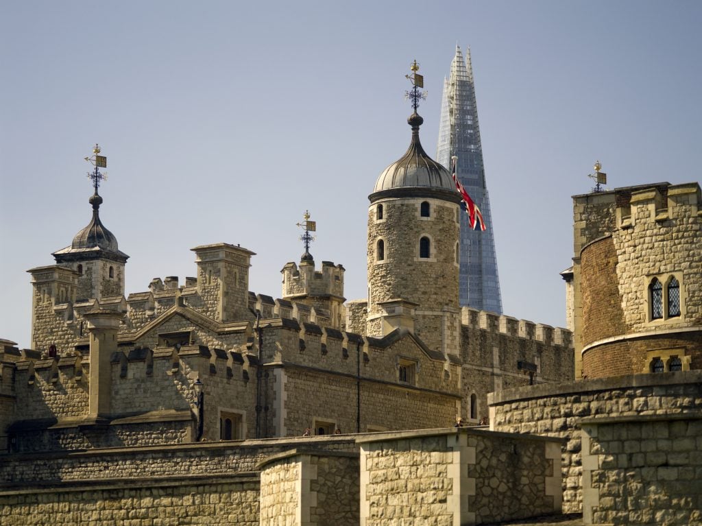 Tower of London with the Shard, a taller building, behind it.