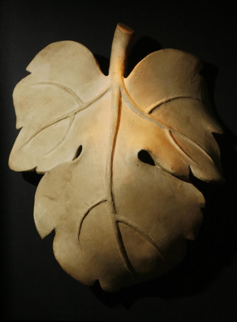 a plaster cast of a gold fig leaf