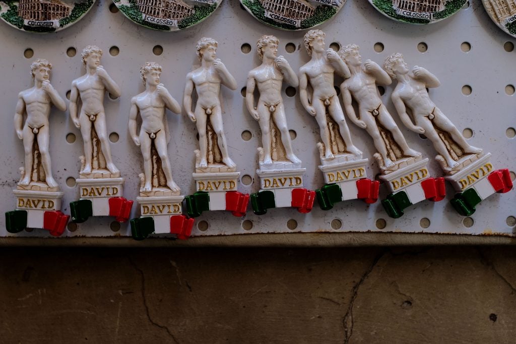 A picture shows magnets depicting famous Michelangelo's sculpture "David", on November 28, 2017 in a souvenir shop in Rome