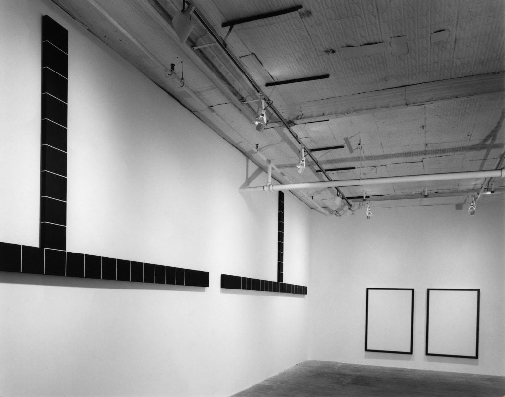 black and white photo of black and white artworks in a gallery