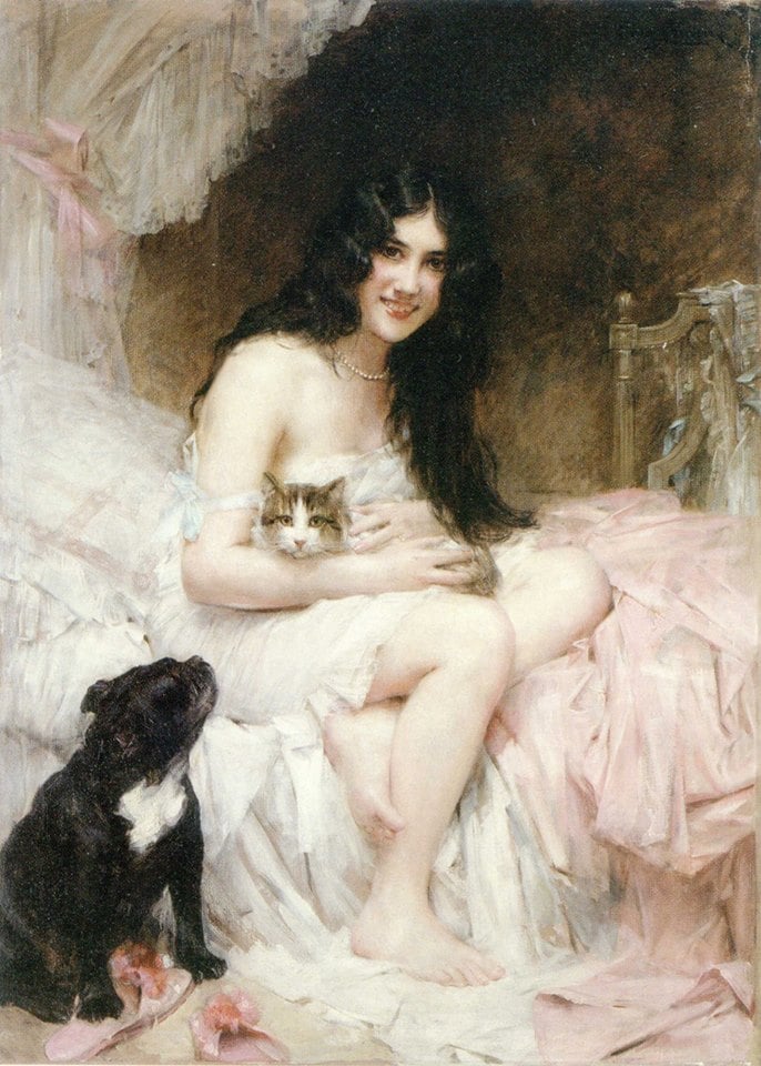 a woman in bed with a cat in her lap