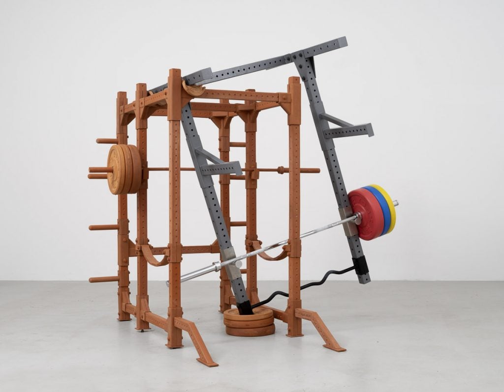 a sculpture is made out of gym weights 