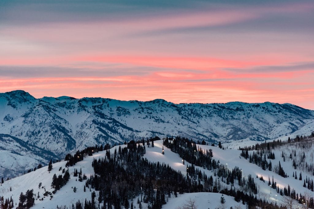 A mountain range with a sunset sky