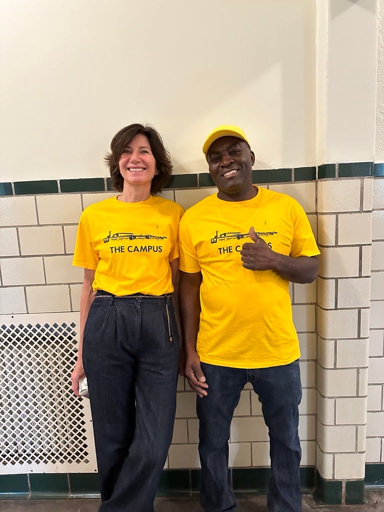 a woman and a man in yellow t-shirts spelling THE CAMPUS