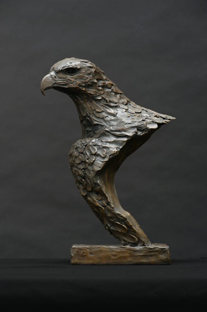 A bronze sculpture by Bruce Little of the head, neck, and partial wing of an eagle.