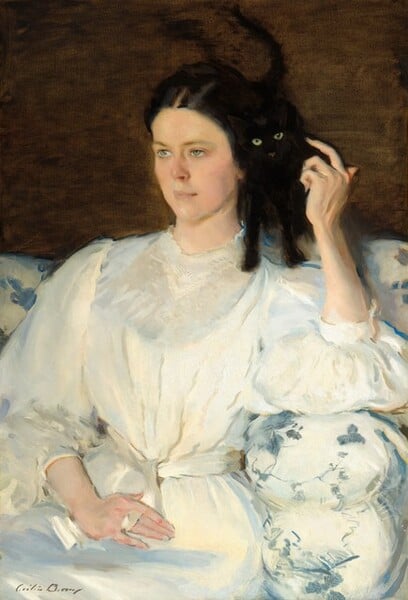 a woman in a white victorian dress pets a black cat