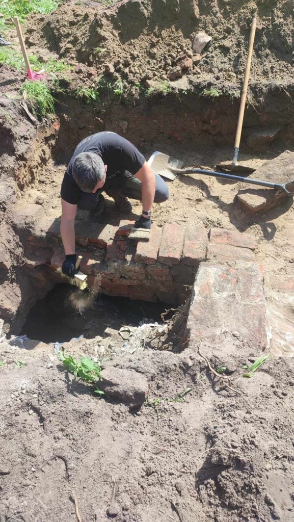 A man excavating a hole in the ground