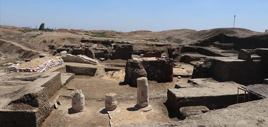 The ruins of a building in a sandy terrain