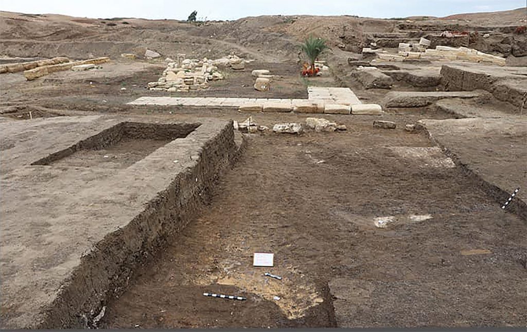 The ruins of a building in a sandy terrain