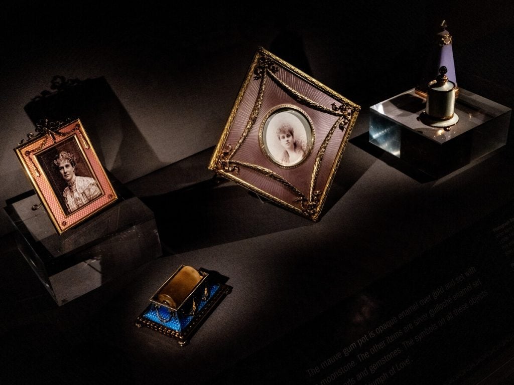 The Fabergé objects from the collection of Brighton and Hove Museum displayed in a darkened display case.