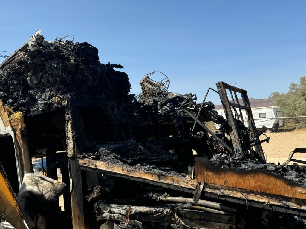 A building badly burned in a desert