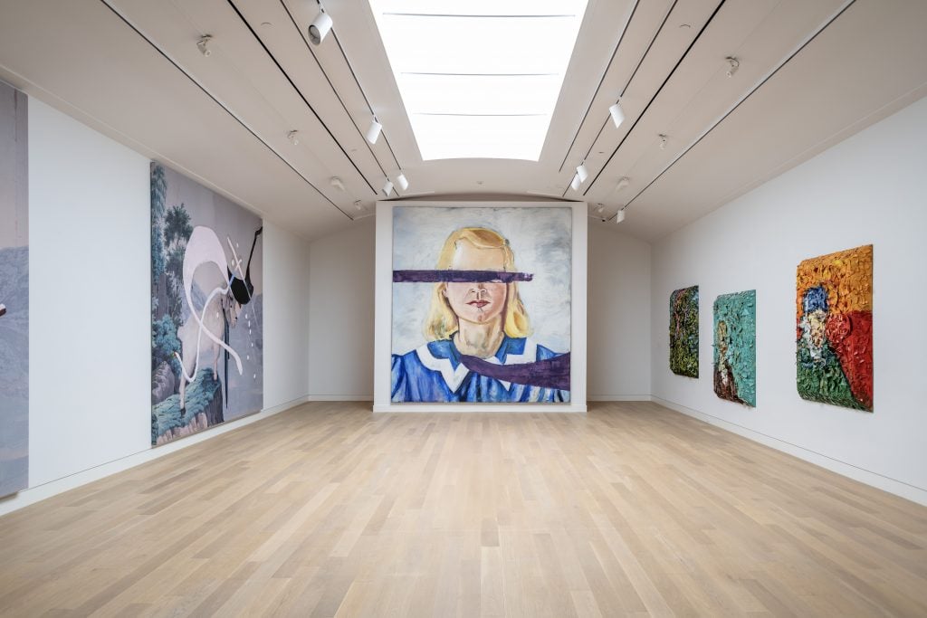 A gallery hung with large paintings by Julian Schnabel