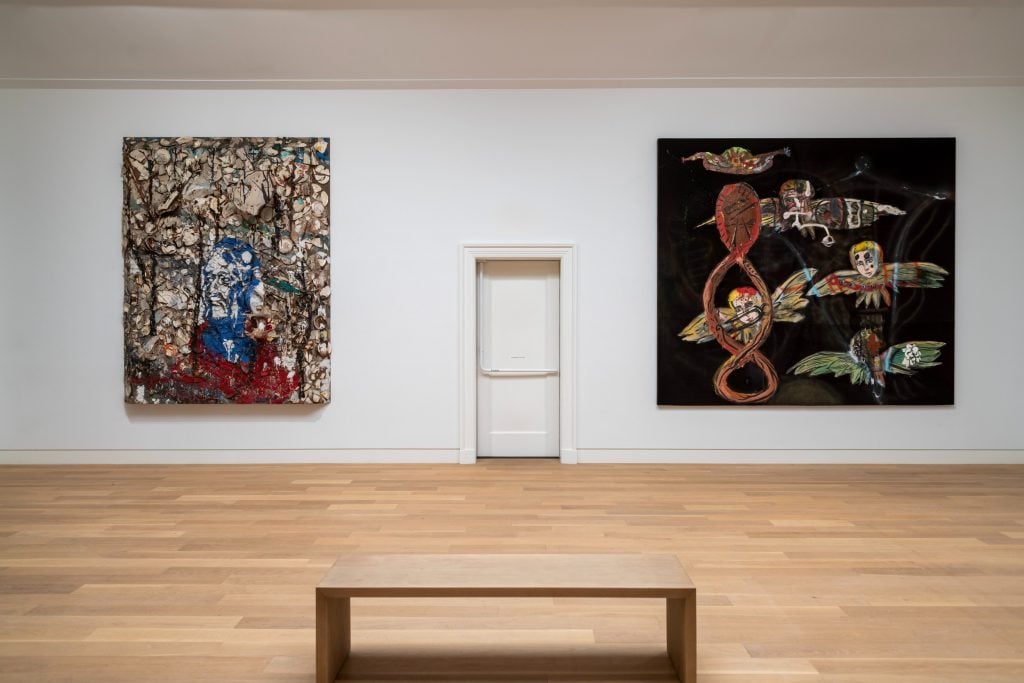 A gallery hung with two large paintings by Julian Schnabel