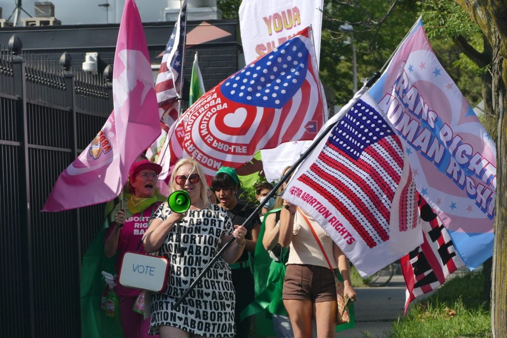 Michele Pred, Whitney Bradshaw and Airco Caravan's "Reproductive freedom" March in which women carried flags and banners in support of access to abortion. 