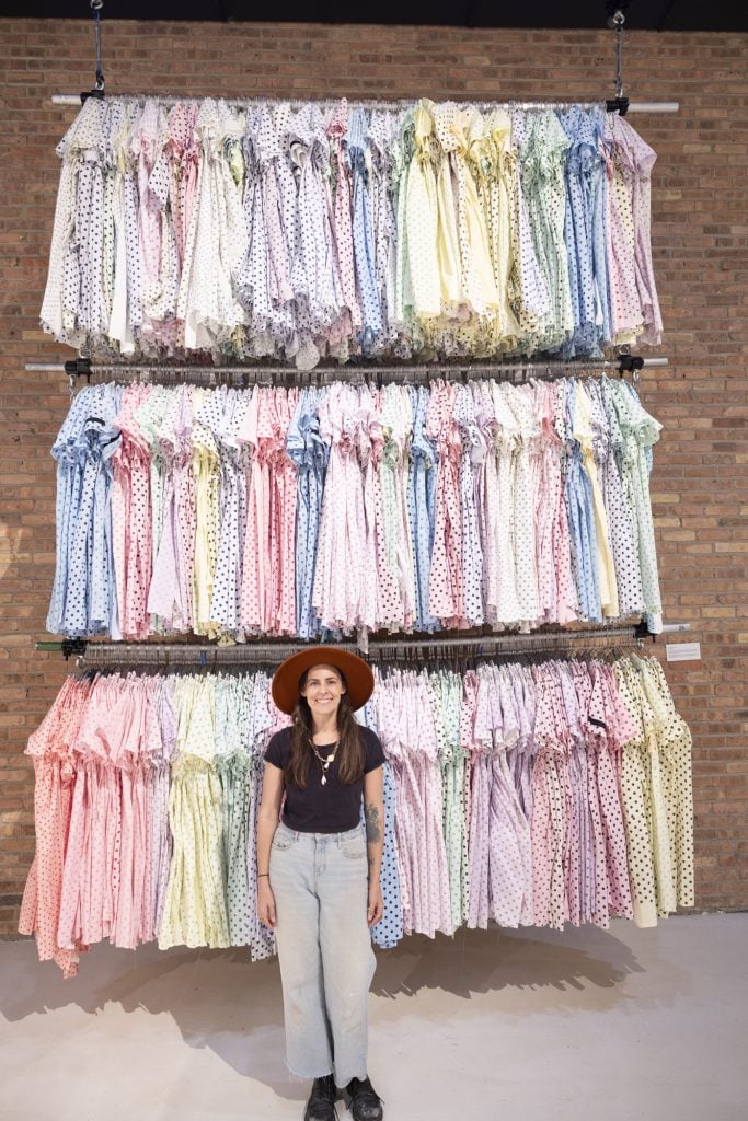 Michelle Hartney mit ihrem Werk <em>Mother’s Right</em>an installation of three shelves of hospital gowns that she sewed to commemorate the women who died in childbirth in the United States in 2013. ” width=”683″ height=”1024″ srcset=”https://news.artnet.com/app/news-upload/2024/08/michelle-hartneys-mothers-right-683×1024.jpg 683w, https://news.artnet.com/app/news-upload/2024/08/michelle-hartneys-mothers-right-200×300.jpg 200w, https://news.artnet.com/app/news-upload/2024/08/michelle-hartneys-mothers-right-1025×1536.jpg 1025w, https://news.artnet.com/app/news-upload/2024/08/michelle-hartneys-mothers-right-33×50.jpg 33w, https://news.artnet.com/app/news-upload/2024/08/michelle-hartneys-mothers-right-1281×1920.jpg 1281w, https://news.artnet.com/app/news-upload/2024/08/michelle-hartneys-mothers-right.jpg 1334w” sizes=”(max-width: 683px) 100 vw, 683px”/></p>
<p id=