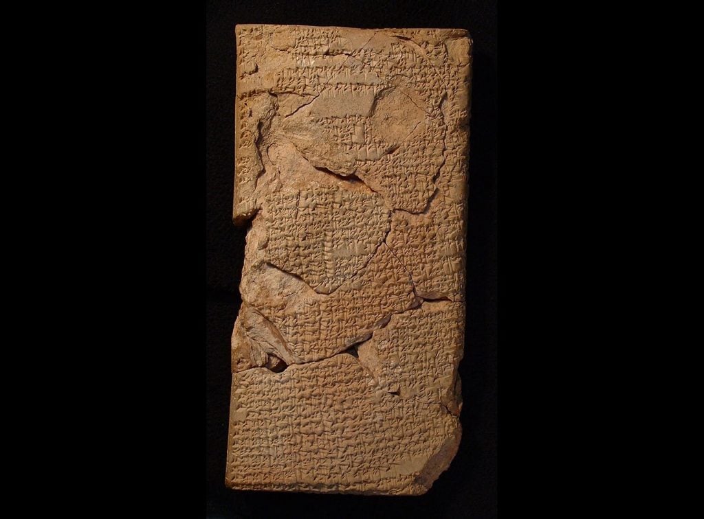 a cuneiform tablet with a black background.