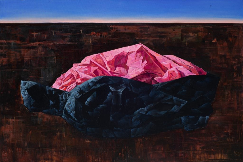 A surreal painting of a pile of pink and black curtains in a barren landscape with a strip of bright blue sky across the top eighth of the painting. On display in the Ukrainian Pavilion at Volta New York.