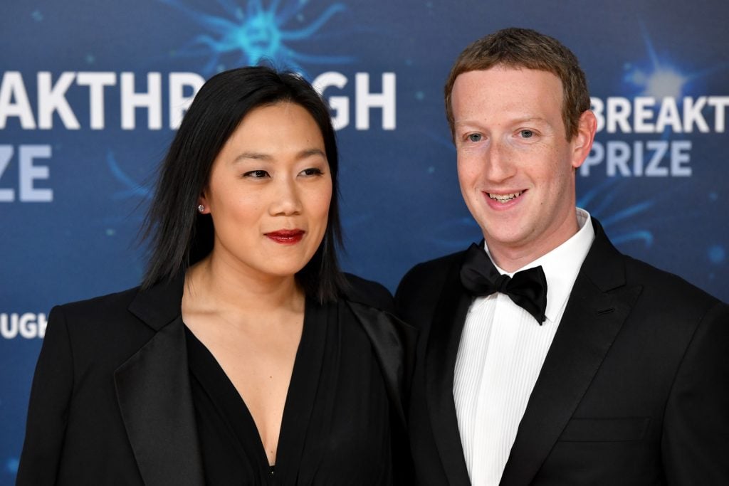 Priscilla Chan and Mark Zuckerberg pose for the camera in evening dress