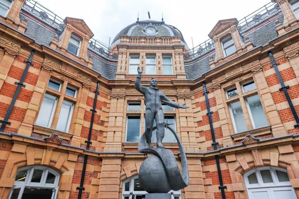 A bronze statue of cosmonaut Yuri Gagarin installed in front of the Royal Observatory, a 17th-century brick building in London