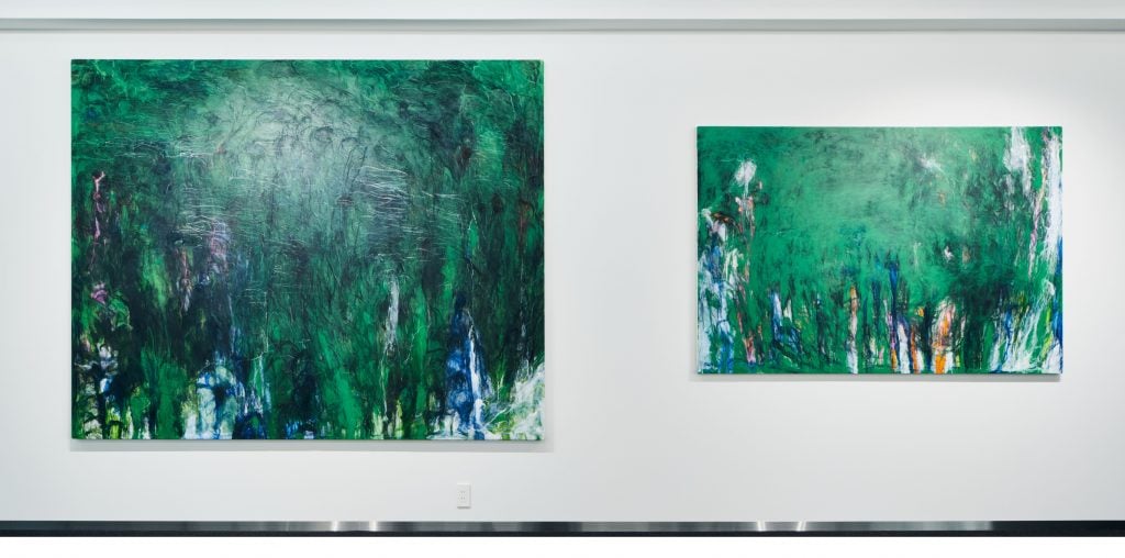 Two green paintings, the left one is larger than the right one.